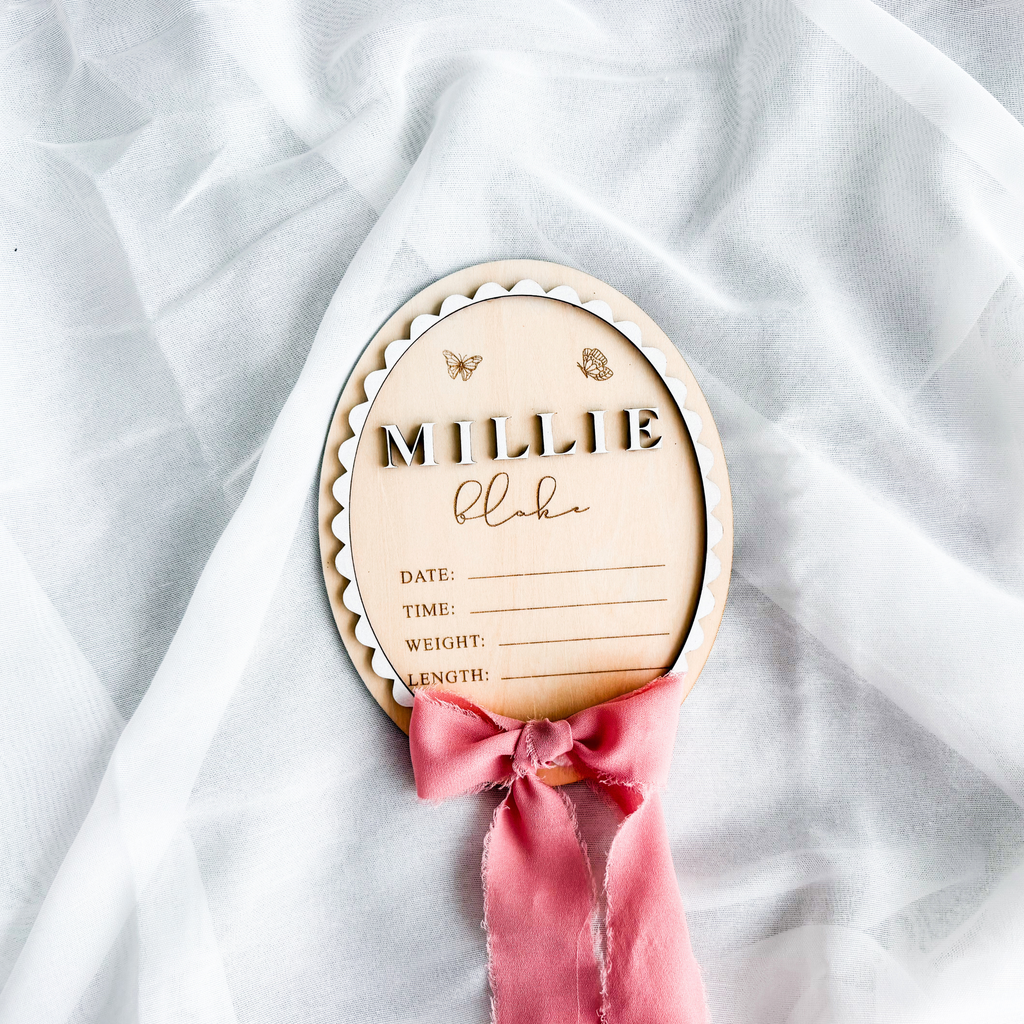 Layered butterfly birth stats sign with blank stat lines and a dusty rose silk ribbon
