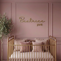 Custom wood baby name sign reading Beatrice Jane in gold on a mauve panelled nursery wall
