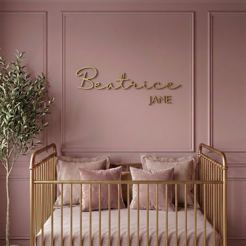 Custom wood baby name sign reading Beatrice Jane in gold on a mauve panelled nursery wall