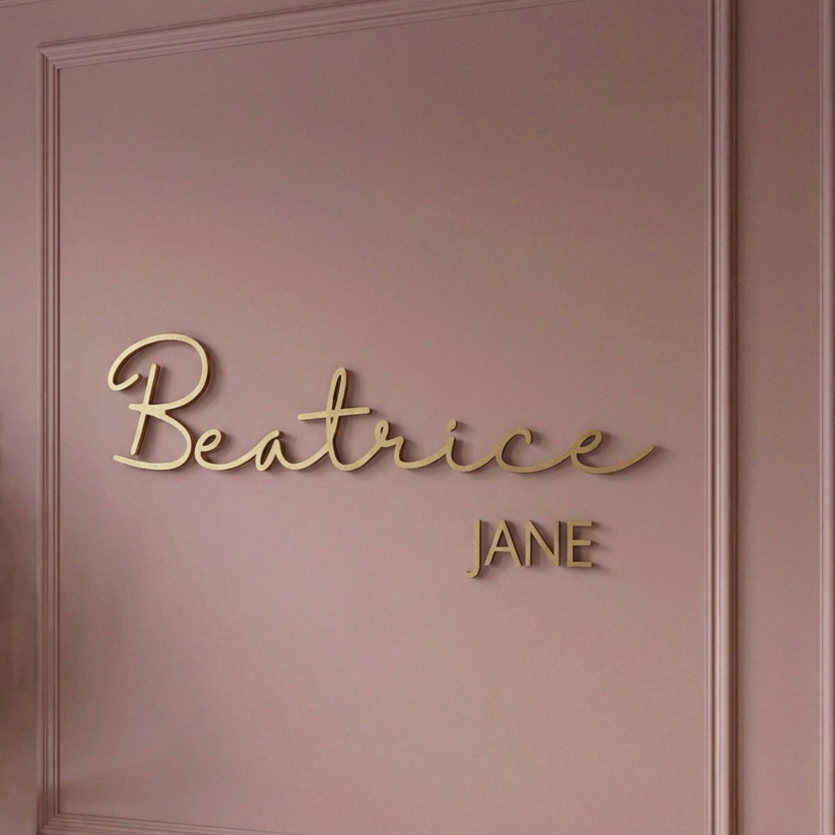Close-up of the Beatrice Jane name sign in gold cursive with the middle name beneath