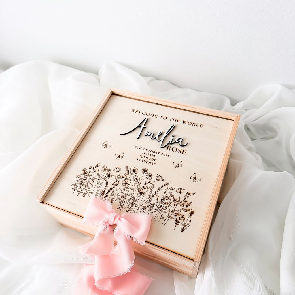 Wildflower baby memory box with a pink silk ribbon bow tied at the corner