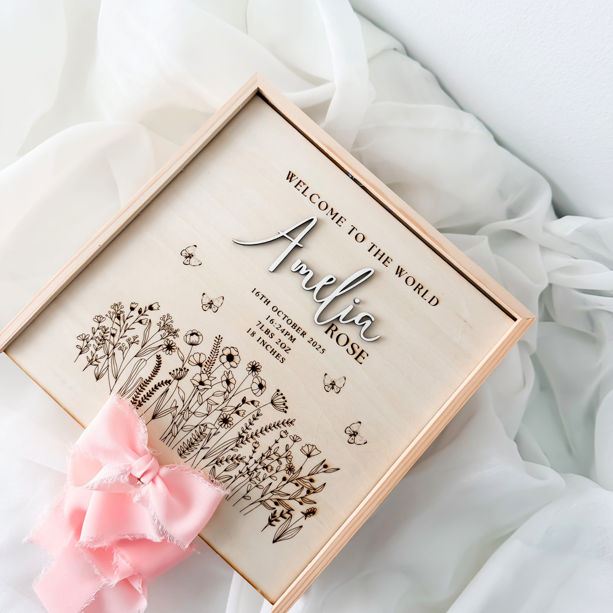 Angled view of the wildflower keepsake box lid with engraved meadow, butterflies and birth details