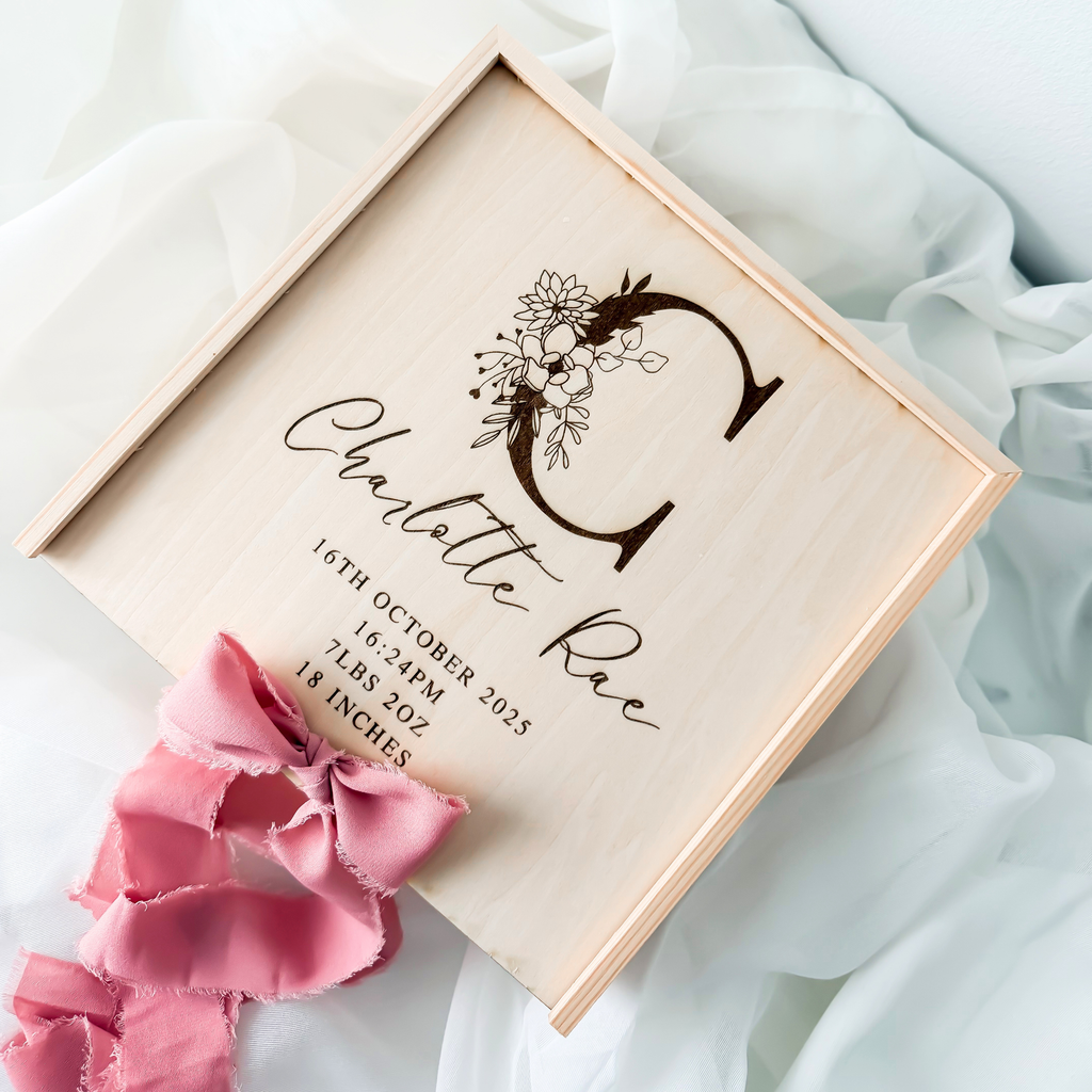 Wooden keepsake box with a floral initial engraving and a dusty rose silk ribbon