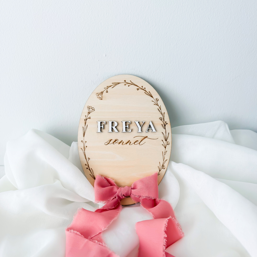 Floral wreath name sign with raised Freya lettering and a rose silk ribbon